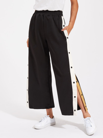 Pantaloni con bottoni laterali