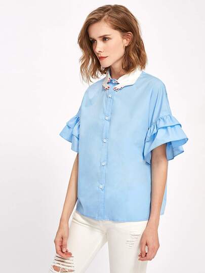 Bluse mit Stickereien und Flötehülse