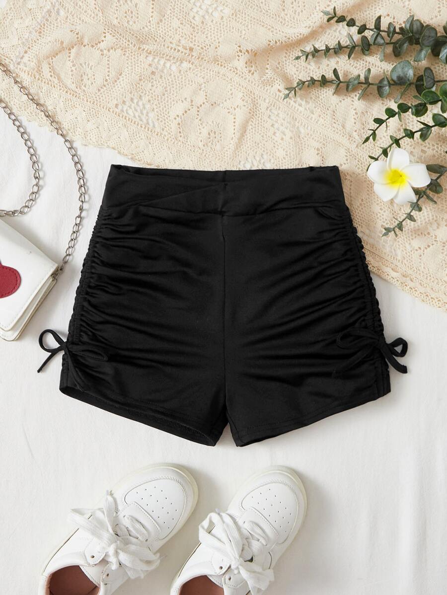 SHEIN Shorts de punto color sólido para niña preadolescente con banda cruzada en la cintura lateral y detalles fruncidos con lazo, ideal para ciclismo