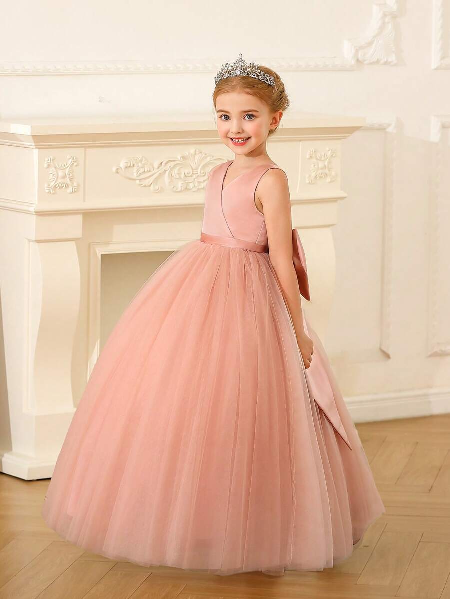 Robe rose pour fille pré-adolescente en maille ajourée avec décoration de nœud papillon et jupe bouffante
