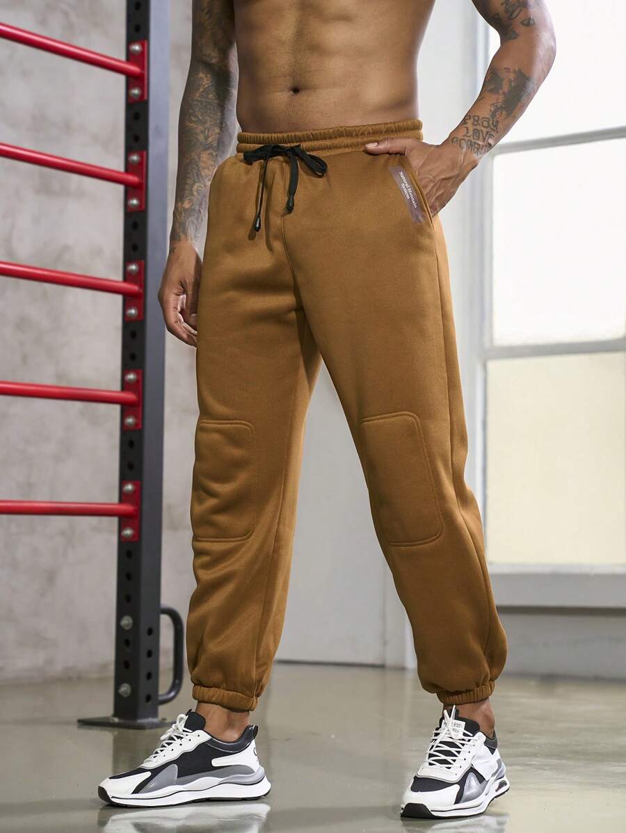 Manfinity Sport Corelite Uomo Pantaloni sportivi con grafica lettera con coulisse a vita tasca inclinata