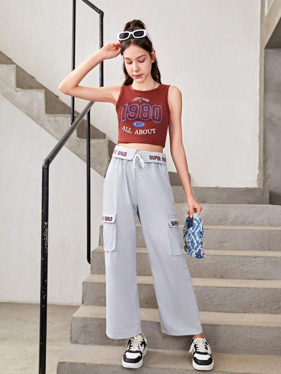 Conjunto De Top Deportivo Estampado Y Pantalones Deportivos Con Bolsillo Y Cordón Para Chicas Adolescentes Que Prefieren Un Estilo Deportivo Y Cómodo