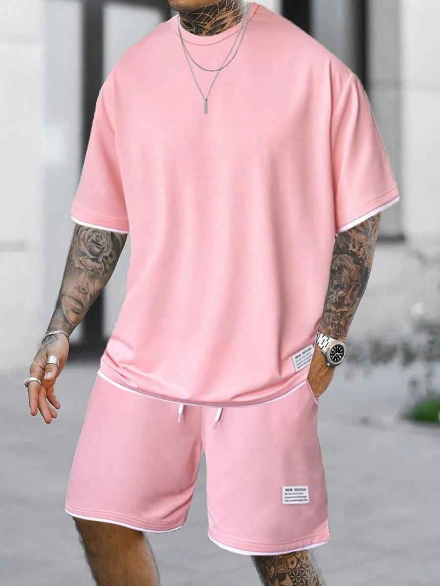 Manfinity Homme Conjunto de camiseta de manga corta y pantalones cortos con recorte de color bloque rosado para salir, para hombre
