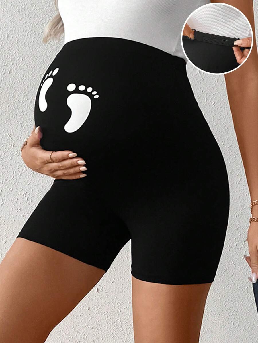 Modmama Leggings cortos y casuales de maternidad con cintura ajustable y estampado de huellas de pies de bebé