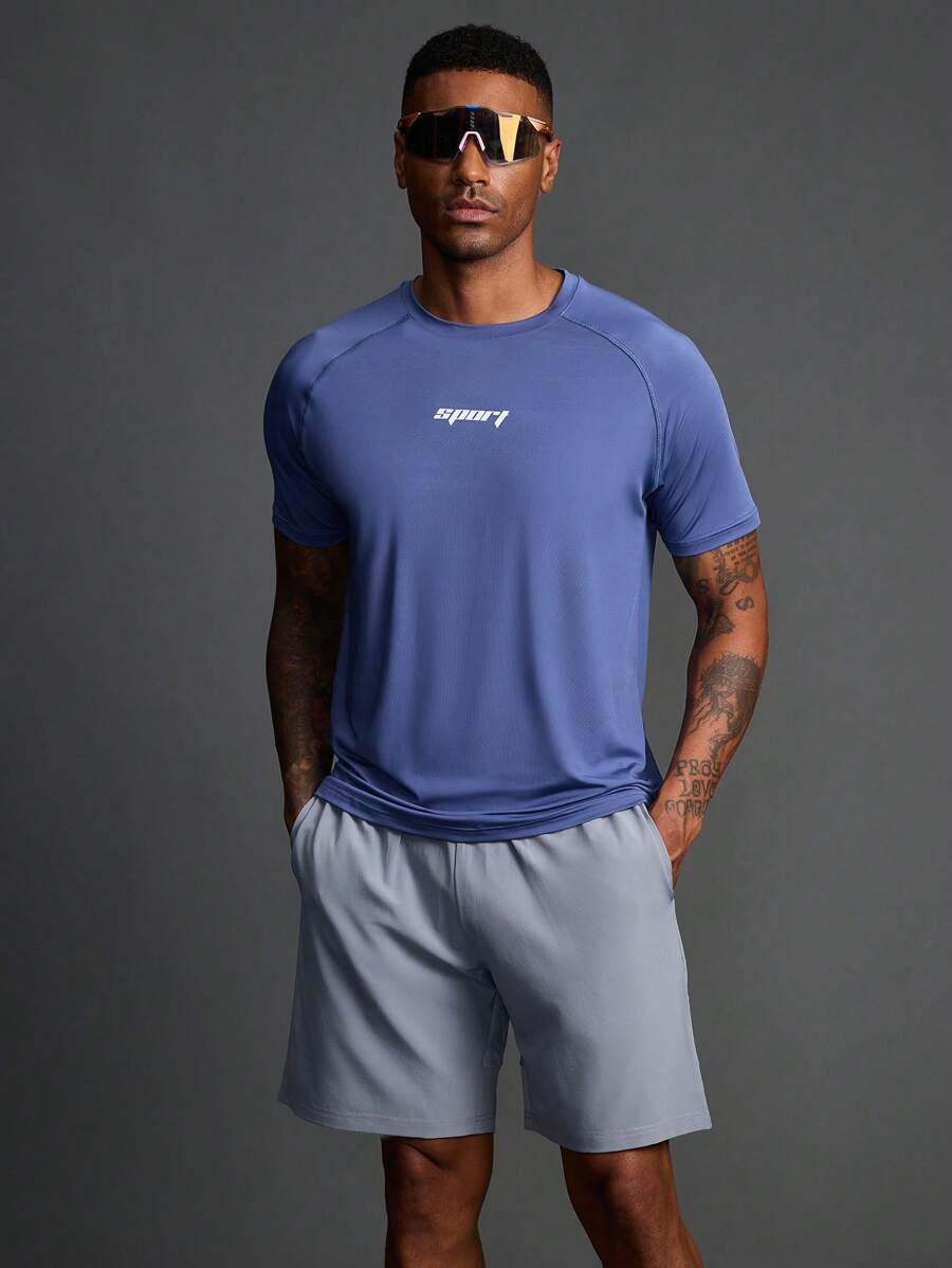 Manfinity Sport Polished Conjunto de camiseta de cuello redondo y manga raglán con estampado de letras y shorts holgados de estilo de novio, ropa deportiva y de gimnasio