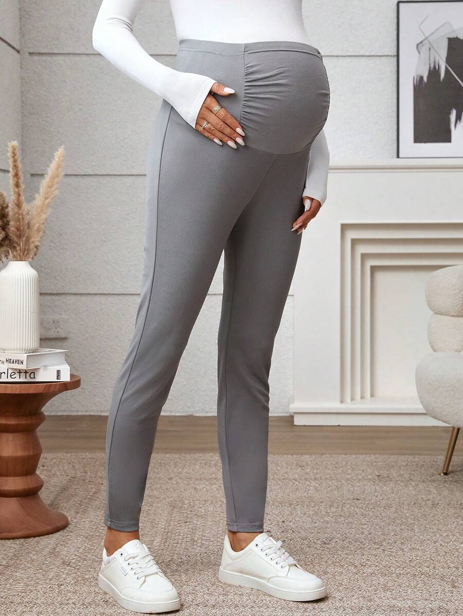 SHEIN Ciążowe legginsy plisowane w jednolitym kolorze z regulowanym stanem i swobodnym krojem