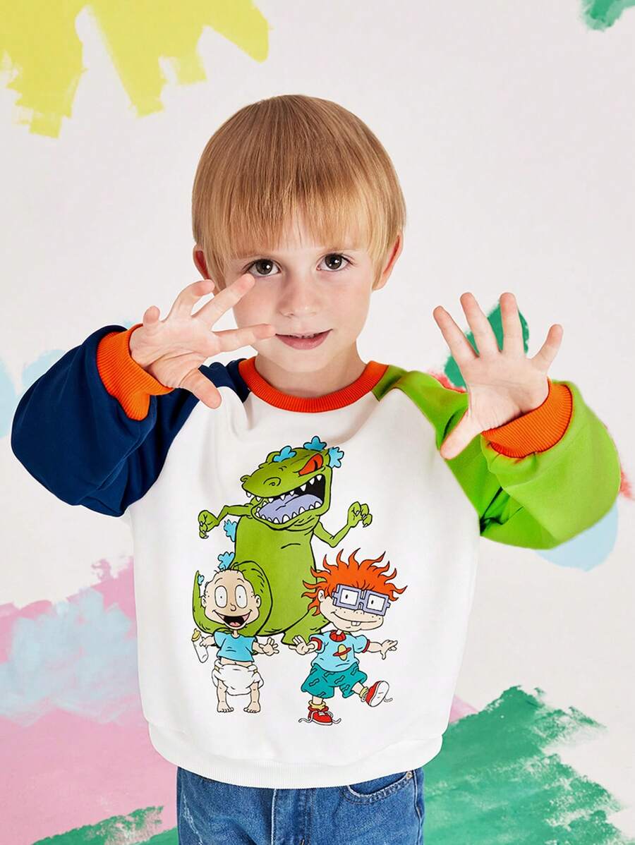 Nick 90s X SHEIN Sudadera informal de cuello redondo para niño con estampado de dinosaurio de dibujos animados y mangas raglán de color block