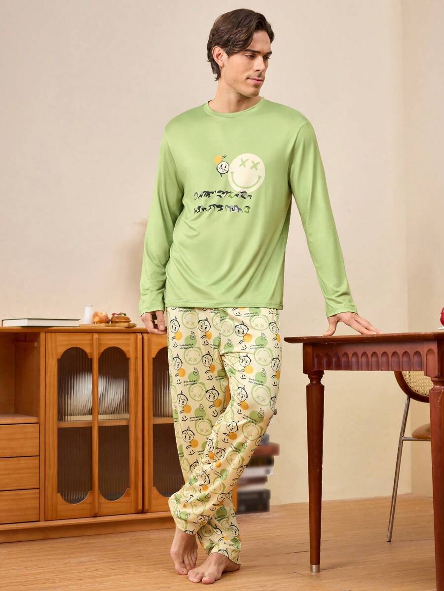 Conjunto de pijama para hombre con top de cuello redondo de manga larga con estampado de cara sonriente y letras, y pantalones
