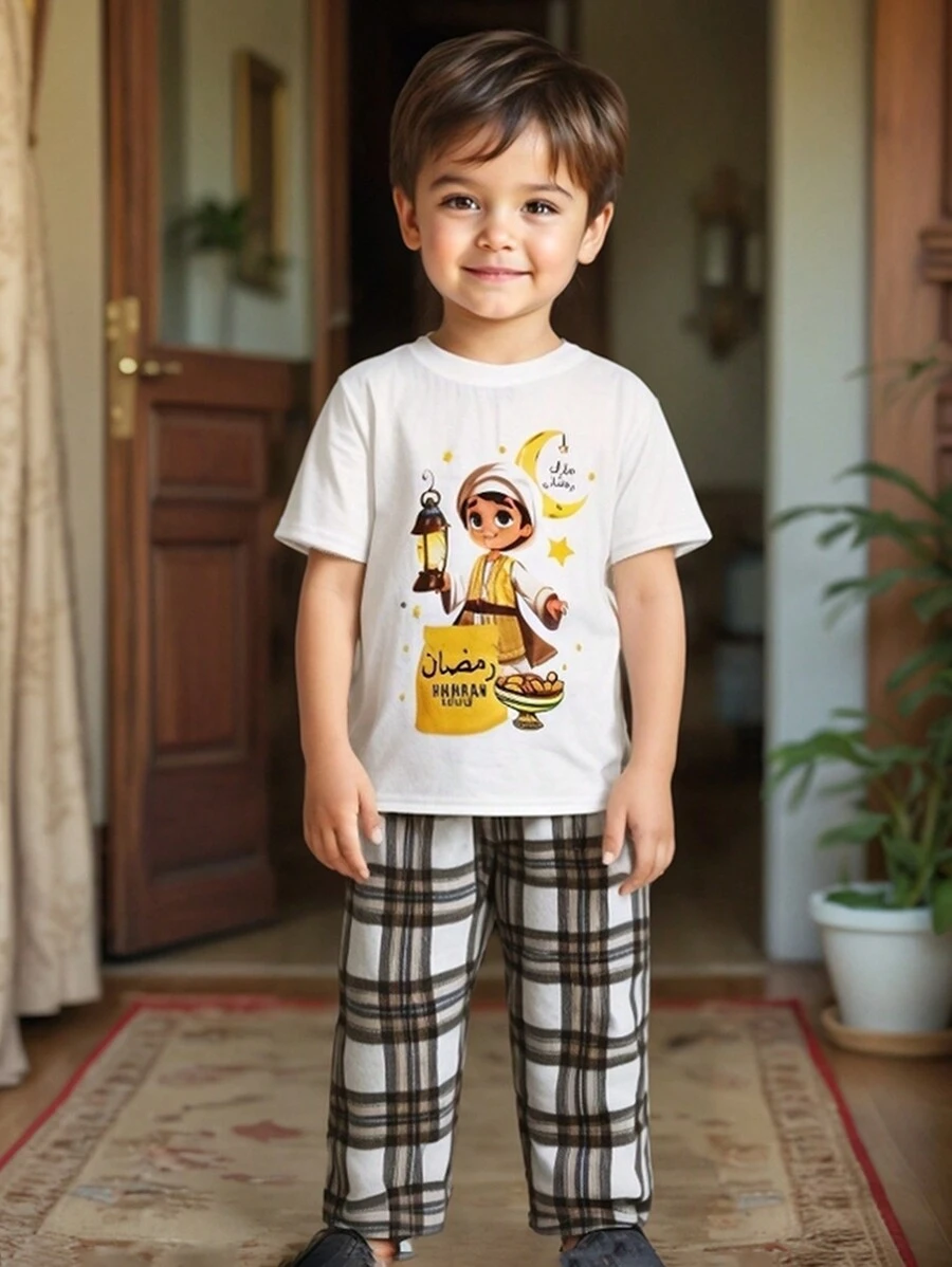 SHEIN Conjunto de pijama informal de 2 piezas con camiseta estampada con luna minimalista y dibujos animados, y pantalón recto a cuadros para niño, cómodo para el Ramadán y días festivos
