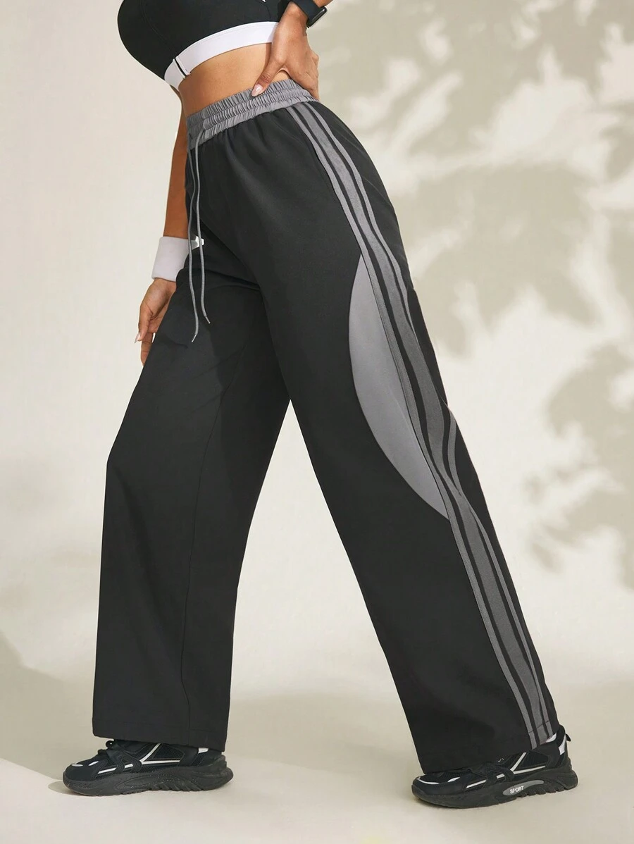Damen Jogginghose mit Kordelzug an der Taille, seitlichen Streifen und weitem Bein