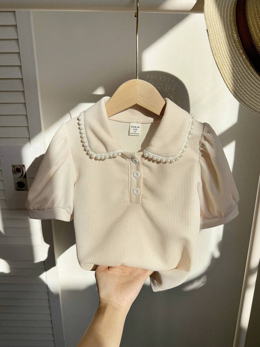 Zomers modieus en elegant geplooide kraag pofmouw T-shirt top, jong meisje