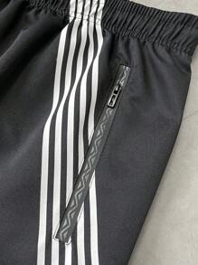 Manfinity EMRG بنطلون رجالي فضفاض بخصر مرن بطبعات نجوم وخطوط، موسم الخريف