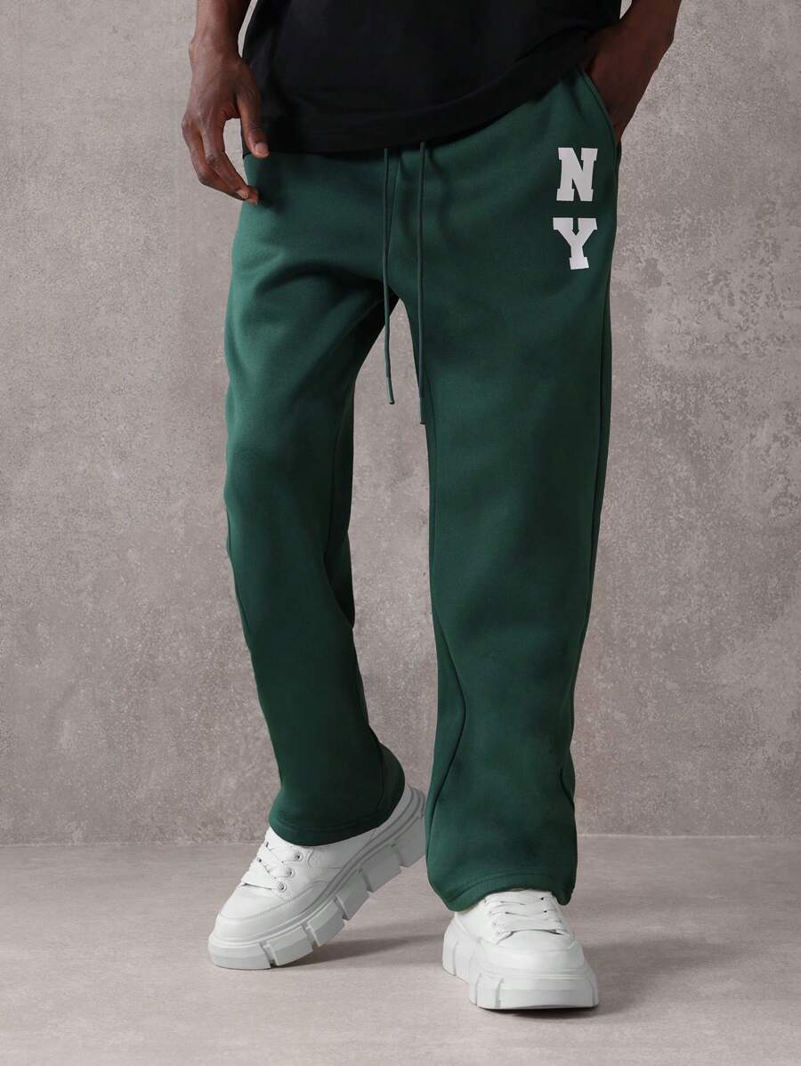 SUMWON Pantalón de chándal esencial de entrepierna caída, de ajuste recto, de rendimiento atlético, de uso diario, con cordón y logo de NY para otoño e invierno