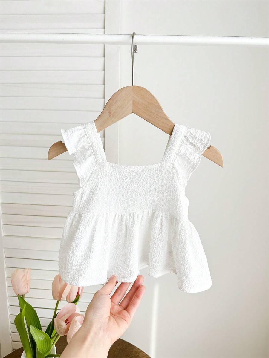 Blusa blanca casual y texturizada con lazo para bebés niñas, versátil para el verano
