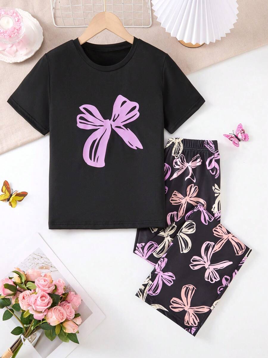 A 2 Pieces Set Of Fashionable Tween Girl Home Clothes, A Casual Purple Bow Printed Round Neck Black Short Sleeved Top Paired With A Black Full Printed Colorful Bow Pattern Straight Leg Pants Set, Suitable For Casual Wear At Home In Spring, Autumn, And Summer
