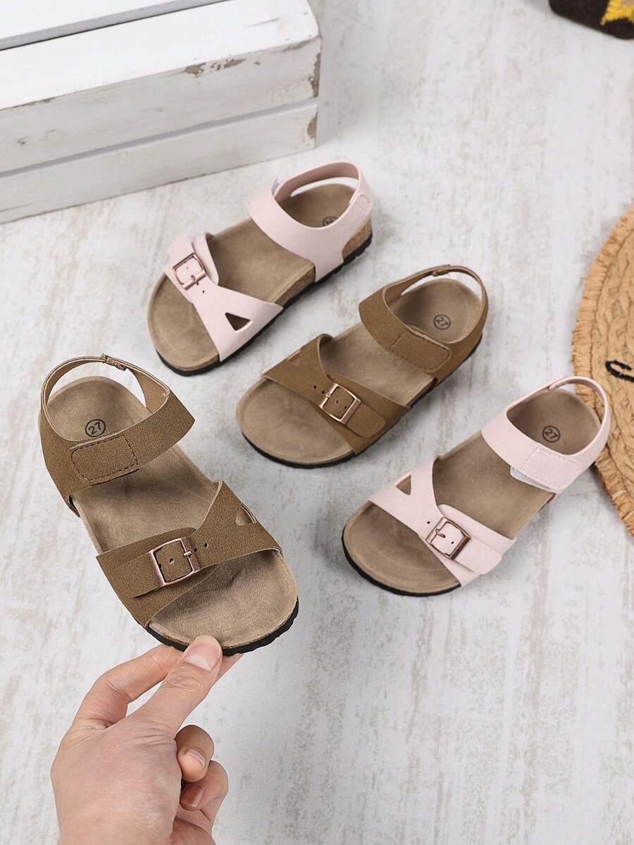 1 par de sandalias planas, anchas y de color rosa claro para niñas y niños pequeños, con correa de PU y hebilla metálica, diseño de correa con , punta redonda, antideslizante, de estilo romano, fashionables y lindas, para estudiantes de 3 a 15 años, uso diario, fiesta, casual, vacaciones, primavera/verano 2025