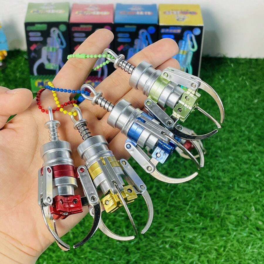 1 Stück zufallsfarbige Krallen-Maschinen Greifer Schlüsselanhänger Mini simulierter bunter Legierung Krallen Anhänger Spielzeug-Accessoire (Die Farbe der Kette ist zufällig).