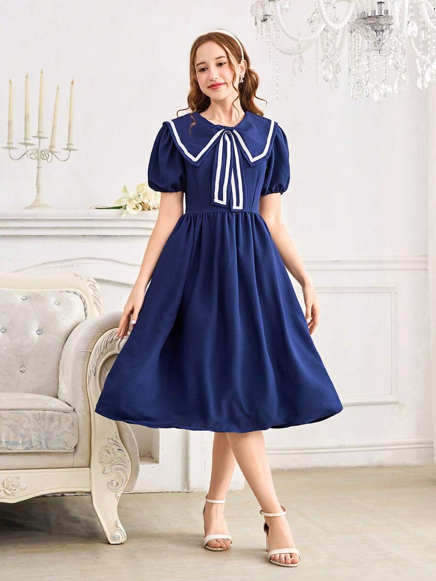 Vestido elegante y dulce con decoración de lazo en el cuello azul marino, de longitud media, con cintura ajustada y mangas cortas. Vestido de línea A ajustado a la cintura y de largo hasta la pantorrilla para chicas adolescentes.