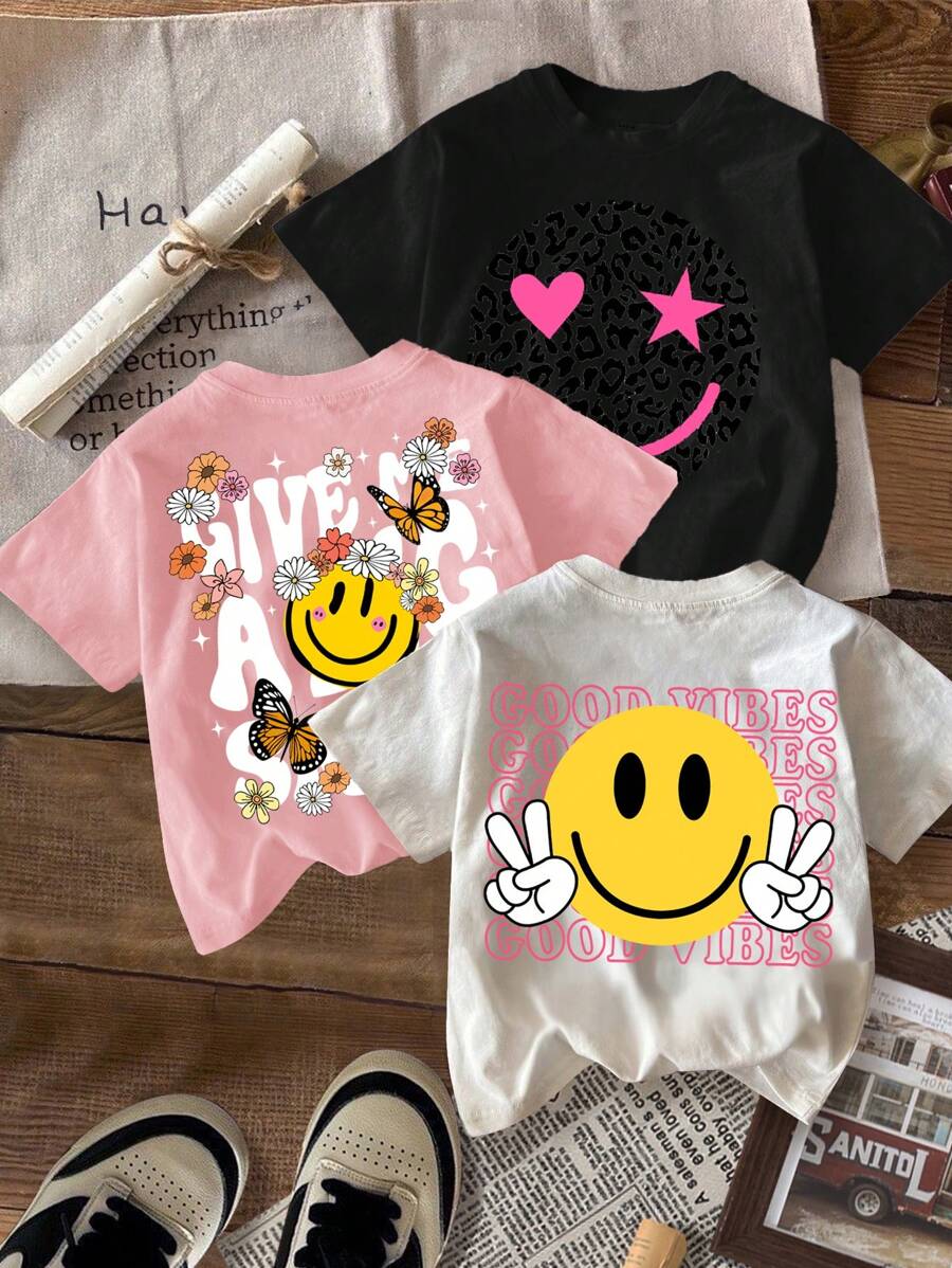SHEIN Camisetas de verano para niñas preadolescentes, paquete múltiple, de estilo minimalista casual con estampado de dibujos animados sonrientes en negro, blanco y rosa