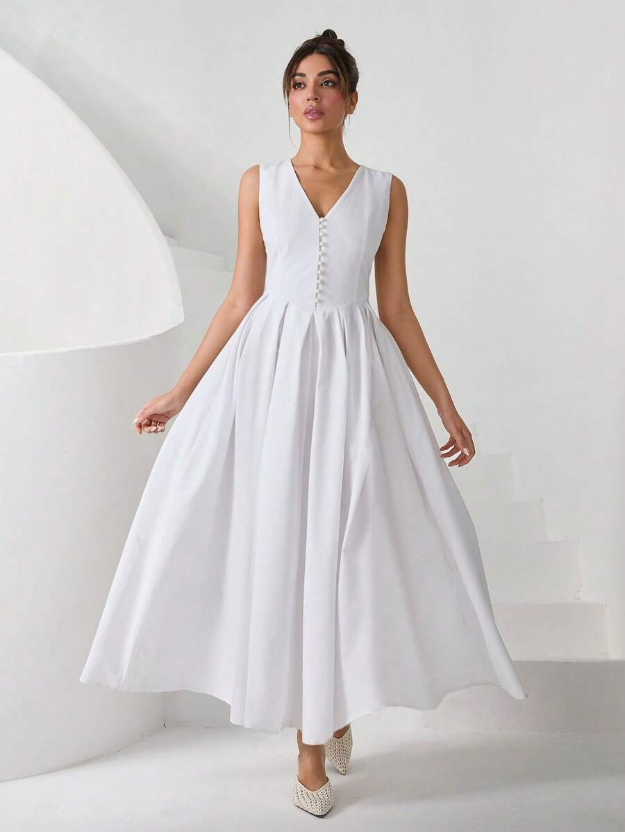 RueChic Elegante vestido midi en línea A en color blanco, con una favorecedora cintura en forma de V, delicados pliegues de princesa para un ajuste esculpido y botones decorativos tipo hongo con un toque vintage. La falda con pliegues de caja añade un movimiento elegante, mientras que la cremallera invisible en la parte trasera o lateral asegura un acabado perfecto. Perfecto para escapadas de verano elegantes, fiestas románticas en jardines y ocasiones nupciales atemporales.