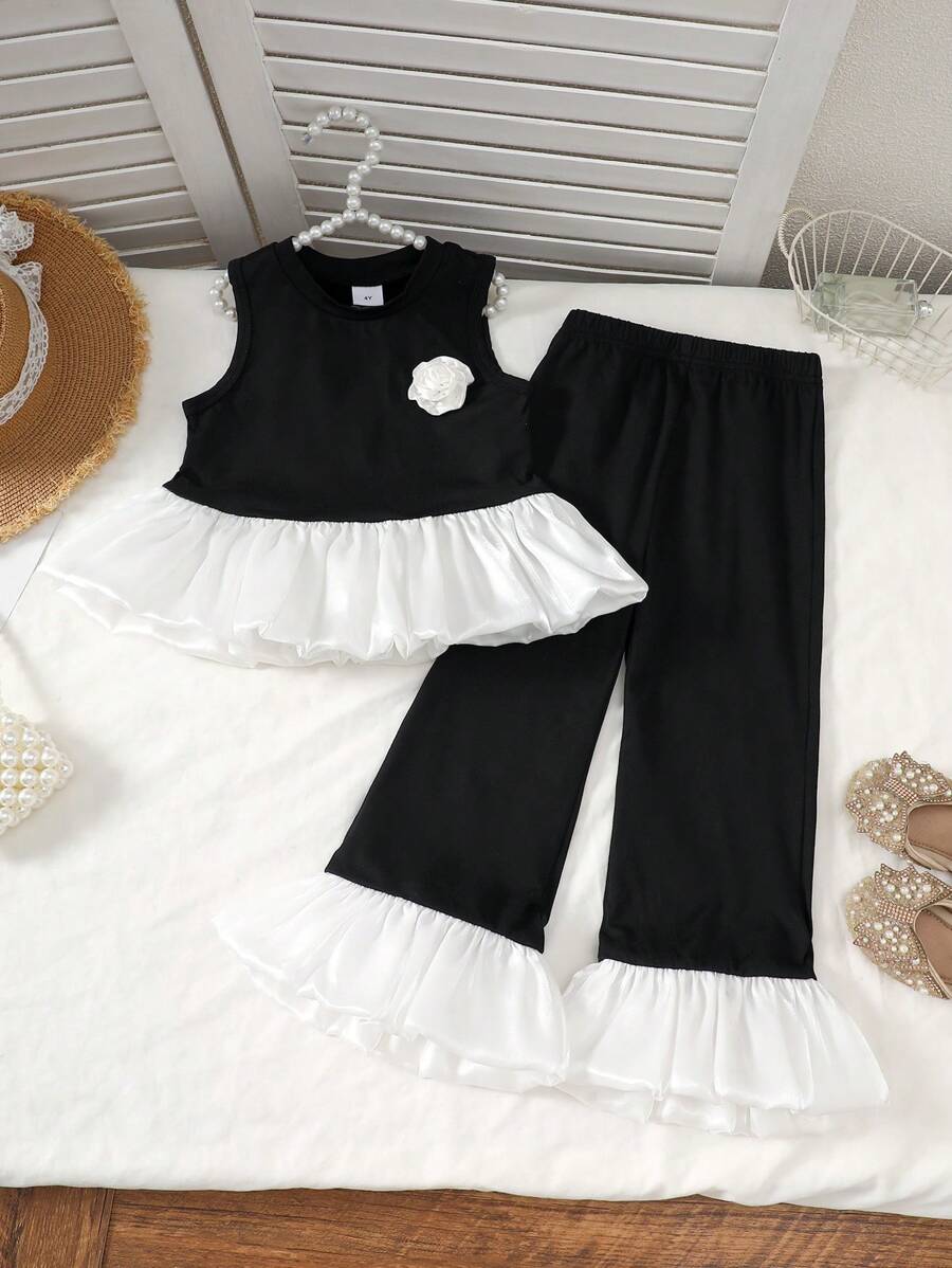 Set de 2 piezas de moda elegante y dulce para niñas de 4 a 7 años, que incluye 1 pieza de blusa sin mangas con panel de punto negro, volantes de organza brillante color albaricoque y detalles florales, y 1 pieza de pantalón negro con cintura elástica y volantes, adecuado para primavera/verano, diario, exterior, viaje, eventos nocturnos, ceremonia y aniversario de cumpleaños