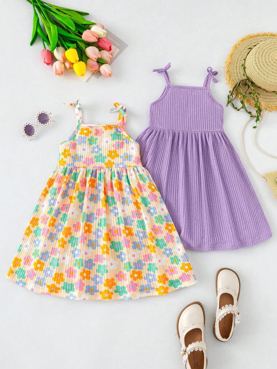 Set de 2 conjuntos de verano para niñas, estampado floral de moda. Uno es un vestido princesa de unicolor con lazo, y el otro es un vestido de tirantes sin mangas estampado con flores coloridas para la playa. Tela ligera y cómoda para el verano.