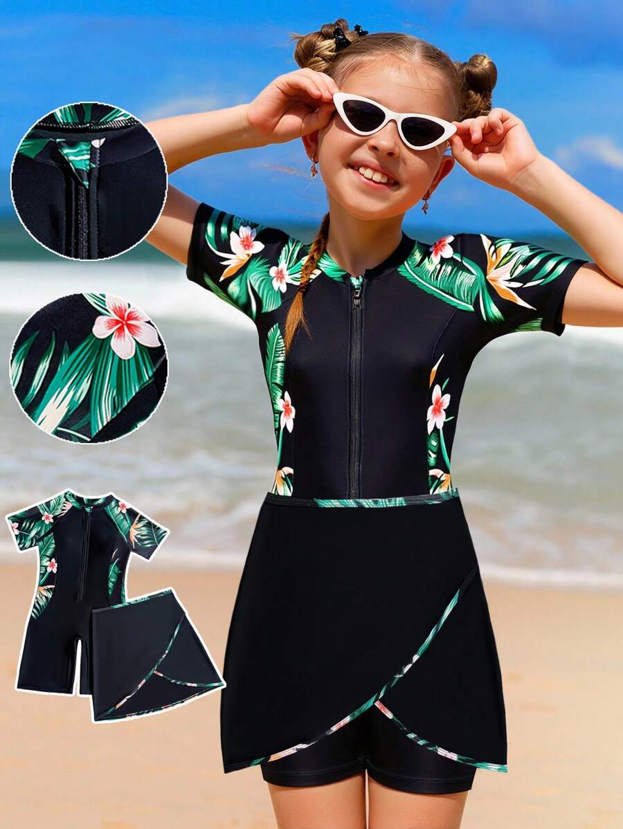 Traje de baño de una pieza con estampado floral para niñas preadolescentes, con cierre de cremallera frontal, manga corta y short negro integrado con patrón de flores estampado a los lados, tipo conjunto de dos piezas