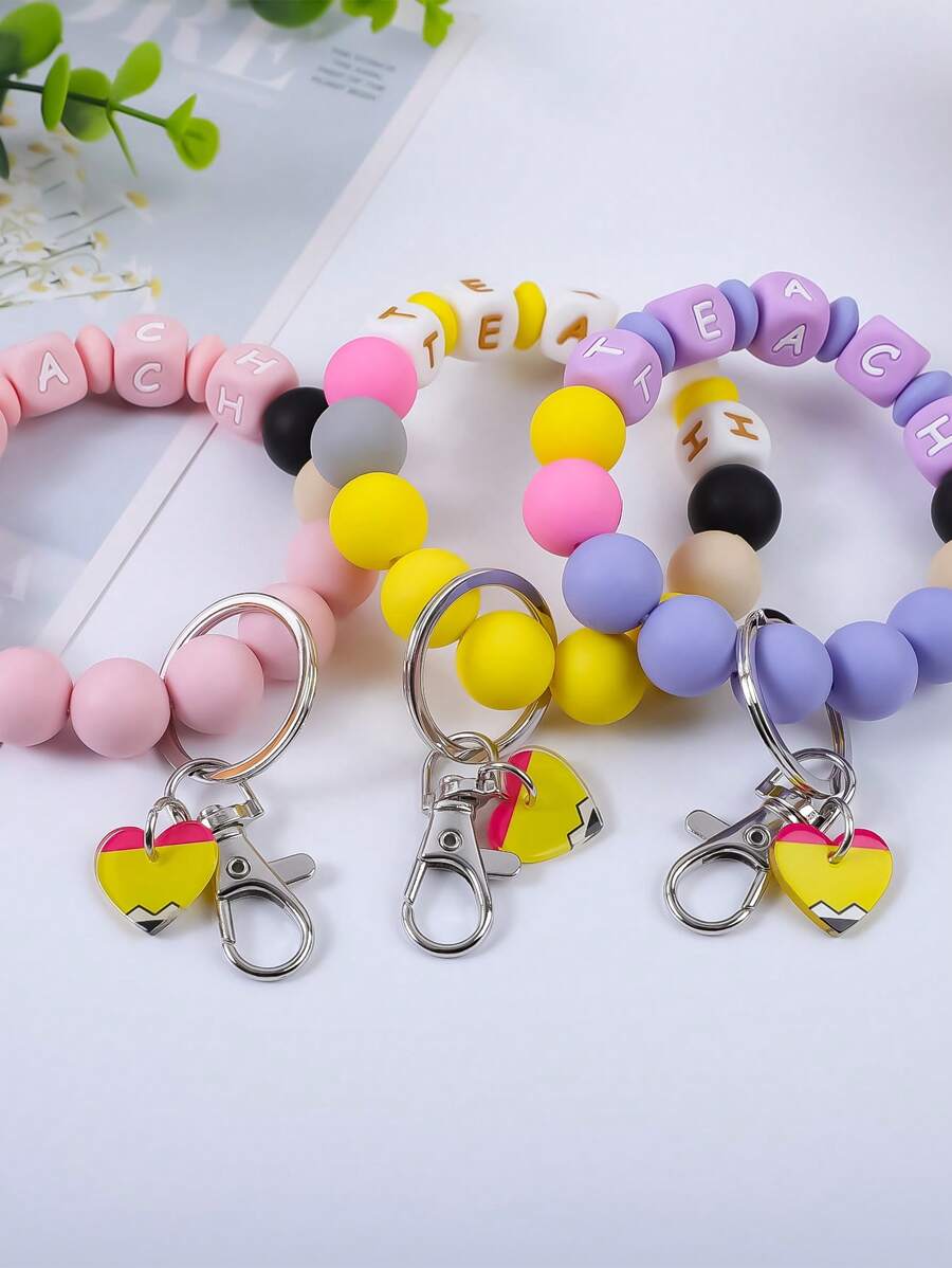 1 Stück bunter perlenbesetzter "TEACH" Buchstabe Silber Schlüsselanhänger, niedlicher kleiner Herz Acryl Anhänger Armband, Rucksack Hängeornament, Geschenk für Lehrer und Studenten Auto Accessoires Taschenbaumler