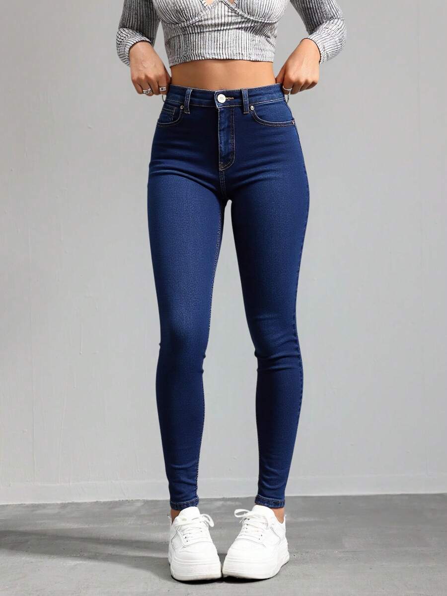 Jeans ajustados de cintura alta en azul marino, tela suave y elástica, ideal para estilos casuales y versátiles