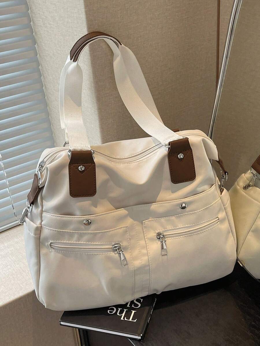 In 2025, The New Fashion Classic Joker Solid Color Large-Capacity Multi-Pocket Contrasting Hand Bill Of Lading Design Leisure Canvas Messenger Bag Is Suitable For Traveling On Campus.