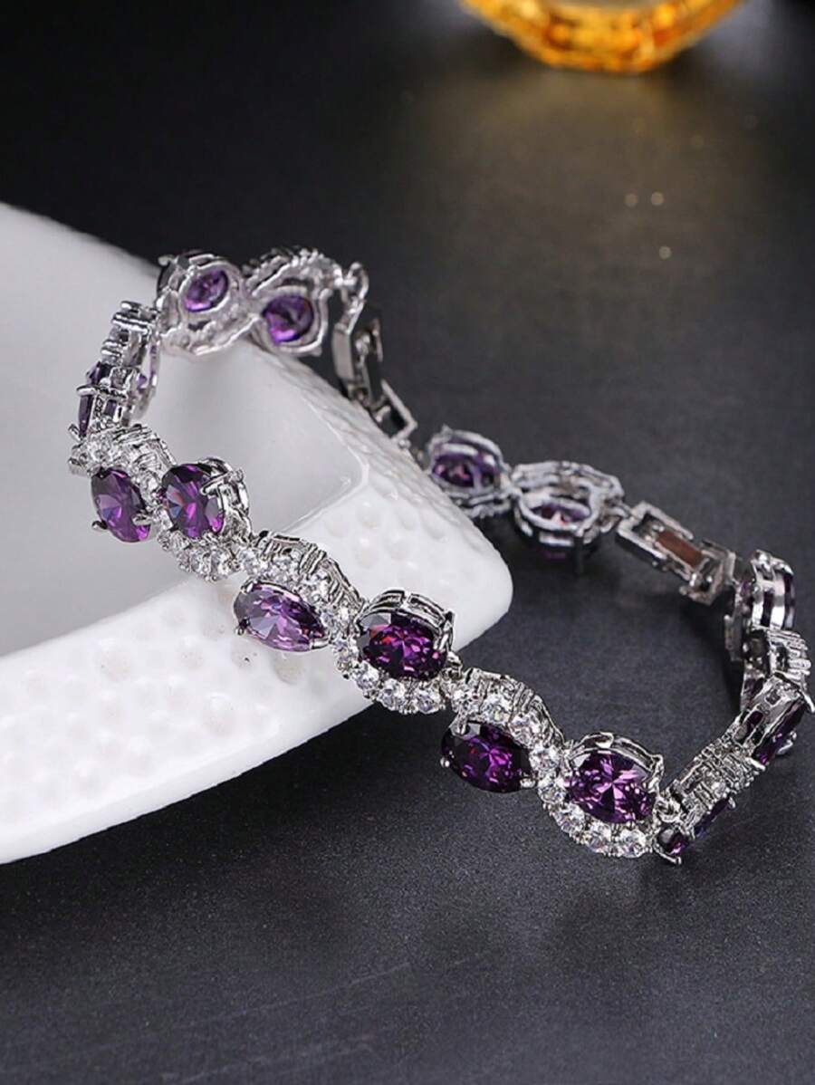 Pulsera elegante y lujosa en forma de S con circonita sintética ovalada de color púrpura, elegante para usar en el trabajo o en fiestas como accesorio