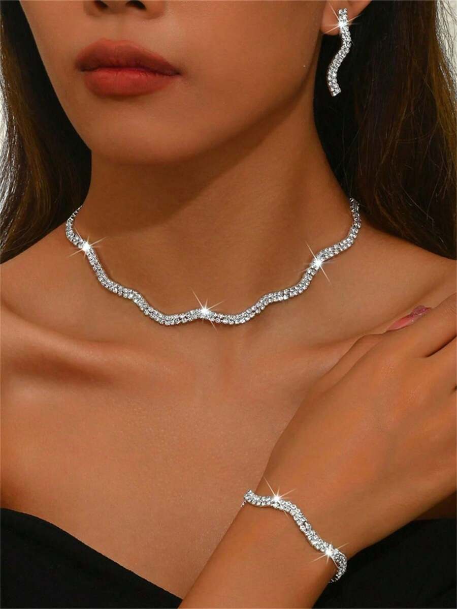 Ensemble de collier, boucles d'oreilles et bracelet à vague brillante de mode. Accessoires élégants en trois pièces pour mariée, mariage et fête