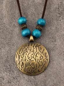 Etiqueta de bronce con cuentas azules