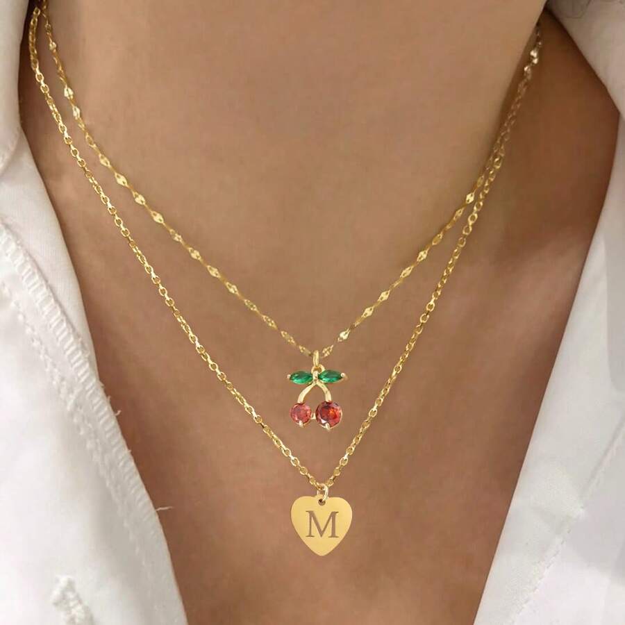 2 pièces/set Simples pendentifs en forme de cœur à motif creux et initial, chaîne dorée à lèvres, colliers multicouches en acier inoxydable pour femmes