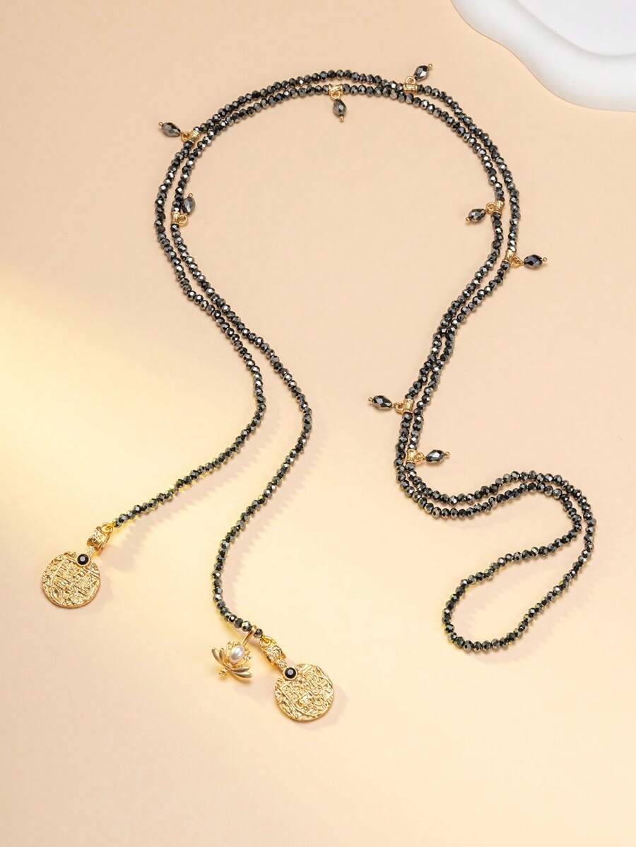 1 collier et 1 paire de boucles d'oreilles, collier de perles noir et doré moyen-oriental, ensemble de bijoux vintage en or ton, collier multicouche exotique, collier contrastant noir et doré, collier à pendentif rond sculpté. Le collier de perles noir et doré évoque le rythme mystique des clochettes de chameaux des nuits étoilées du désert moyen-oriental. Porter cet ensemble de bijoux est un identificateur unique d'une promenade dans un marché moyen-oriental.