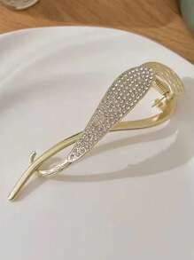 Pince torsadée en strass dorée