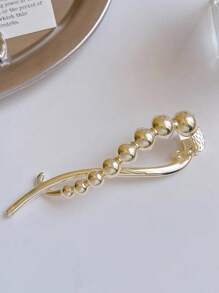 Clip torsadé en perles de couleur or