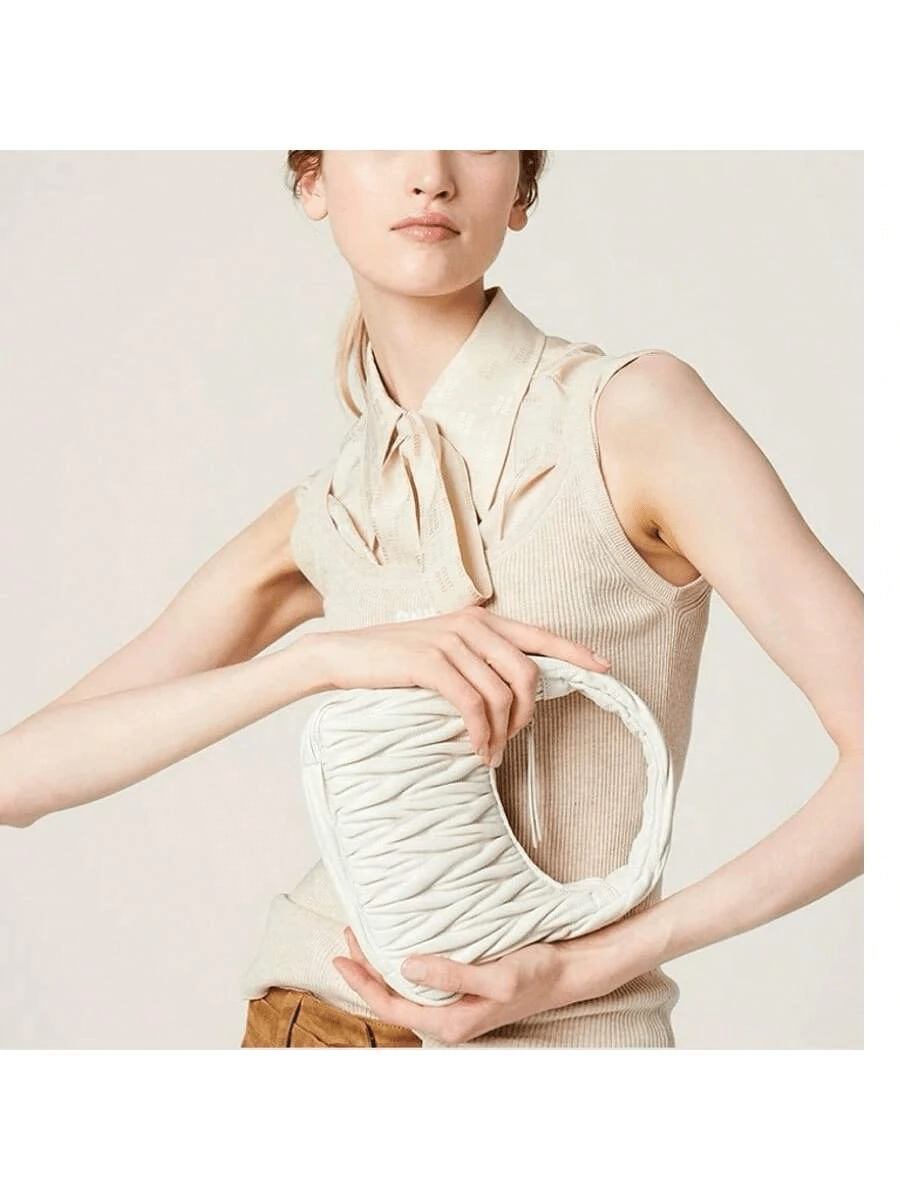 A small sheepskin dumpling bag under the armpit, a one-shoulder crossbody crescent-shaped women's bag, and a mini cloud bag