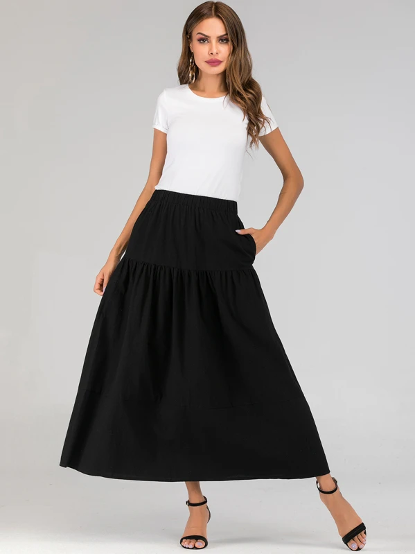 Jupe évasée à taille élastique unicolore avec poches Jupe évasée à taille élastique unicolore avec poches