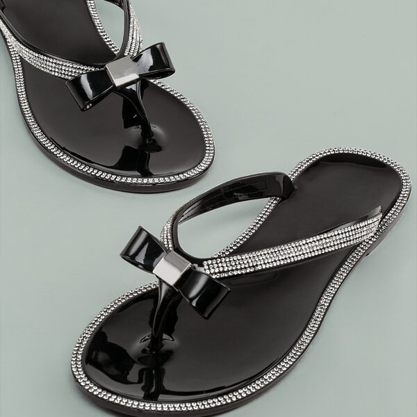 black jelly sandals with bow