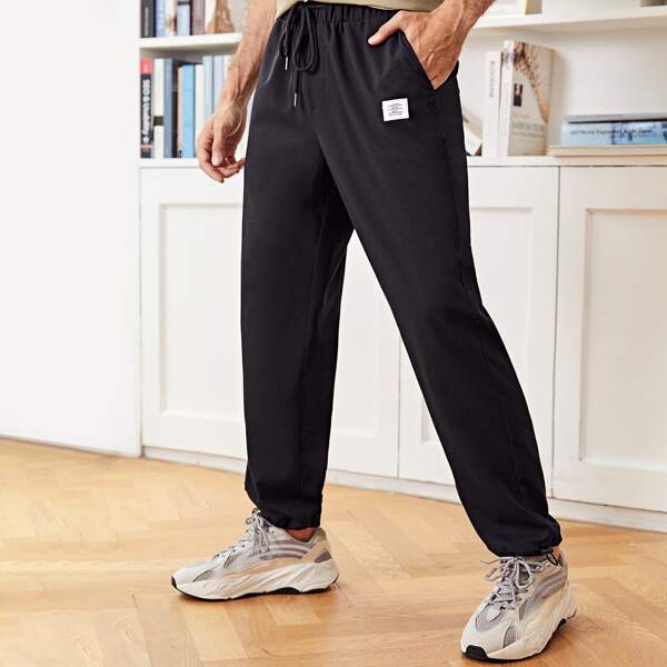 

Men Drawstring Waist Letter Patch Carrot Pants, Black