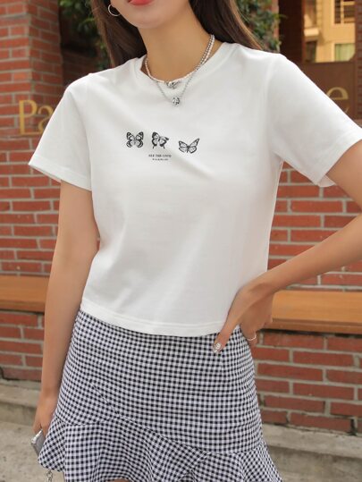 Camiseta gráfica con diseño de mariposa y eslogan "VE EL BIEN CAMINANDO" para el verano, top corto para mujeres