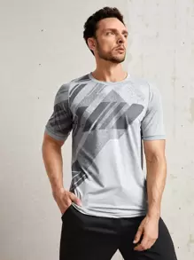 Manfinity Fitness Playera deportiva para hombre con estampado geométrico, camiseta deportiva para entrenamiento - Gris Claro - Ver 1