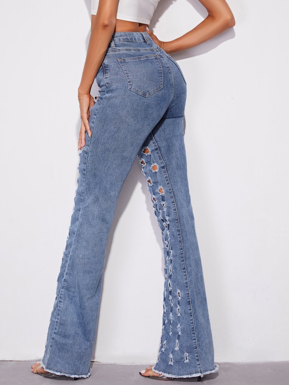 Slant Pocket Perforated Flare Leg Raw Hem Jeans