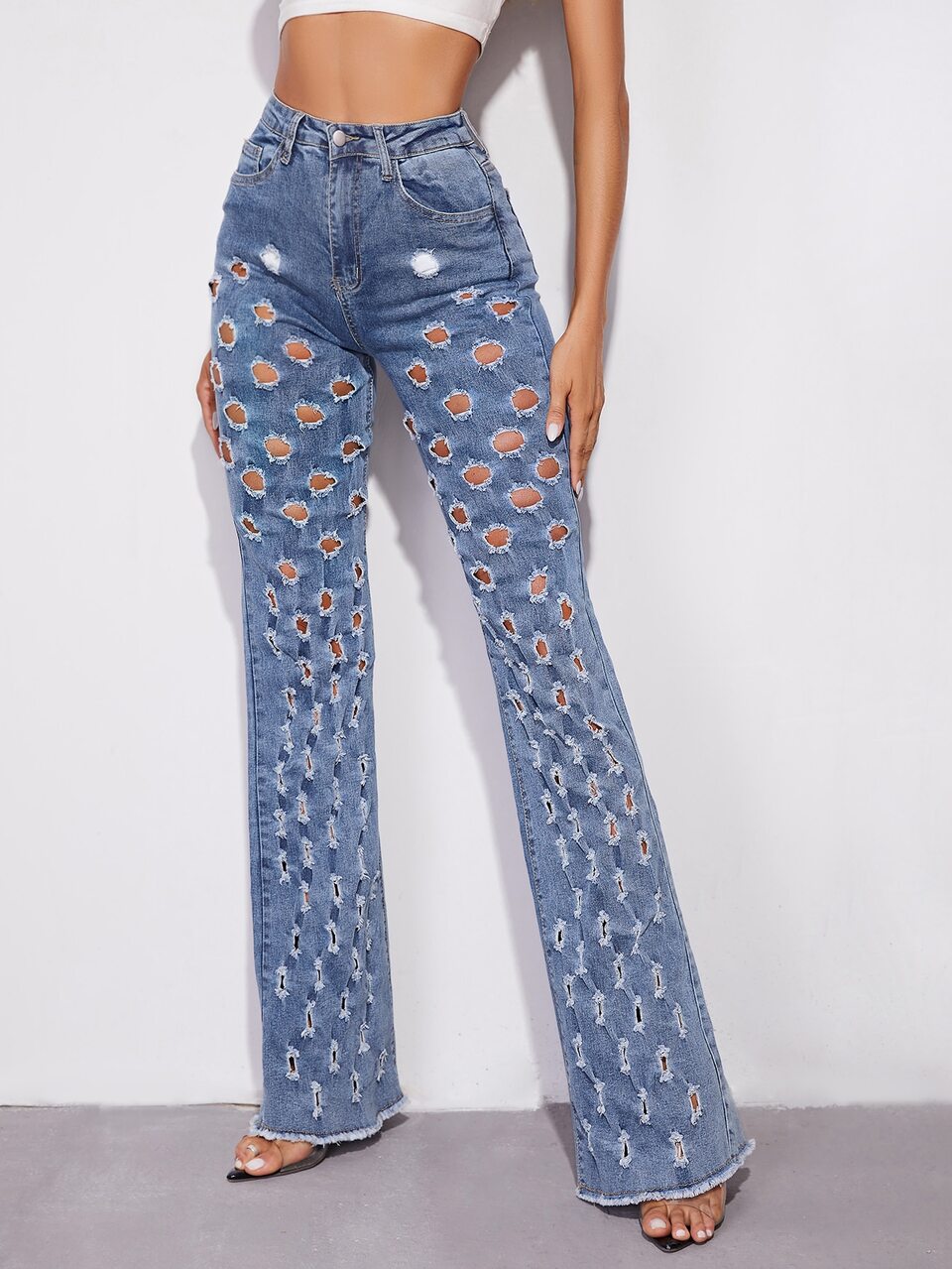 Slant Pocket Perforated Flare Leg Raw Hem Jeans
