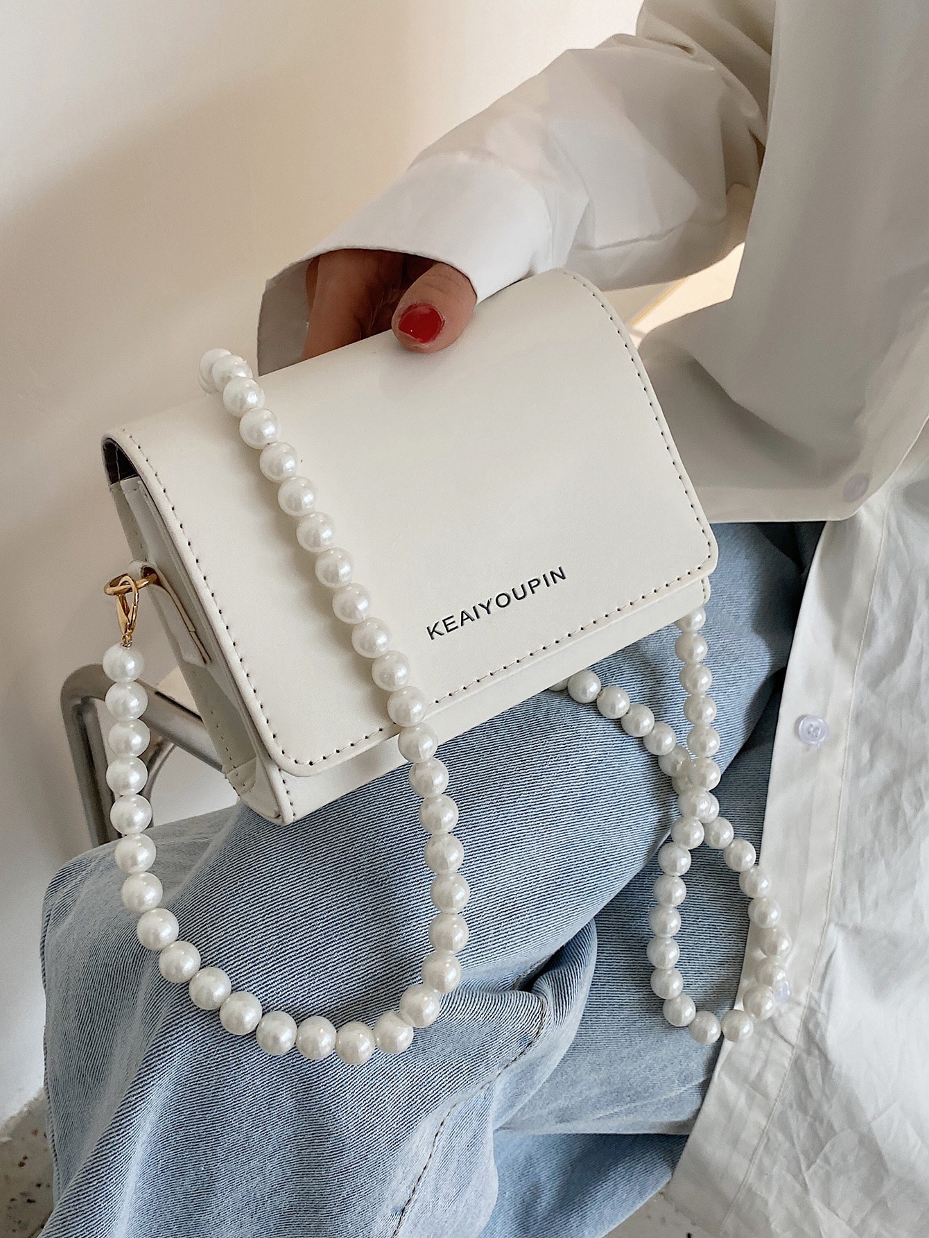 Pearl strap crossbody bag
