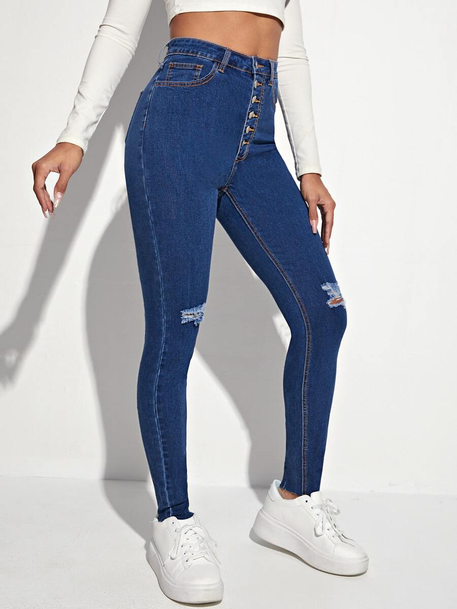Jeans ajustados desgarro con botón