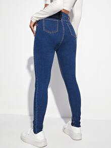 Jeans ajustados desgarro con botón