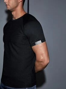 Manfinity Fitness Camiseta deportiva de manga raglán con detalle reflectante, estilo novio, para entrenamiento