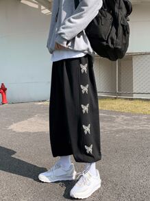 Manfinity Pantalones flojos de ajuste holgado para hombre con estampado de mariposas y dobladillo con cordón - Negro - Ver 1